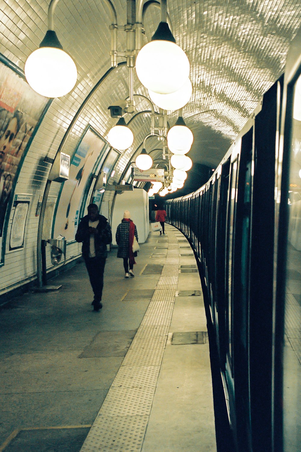 man in black suit walking on hallway