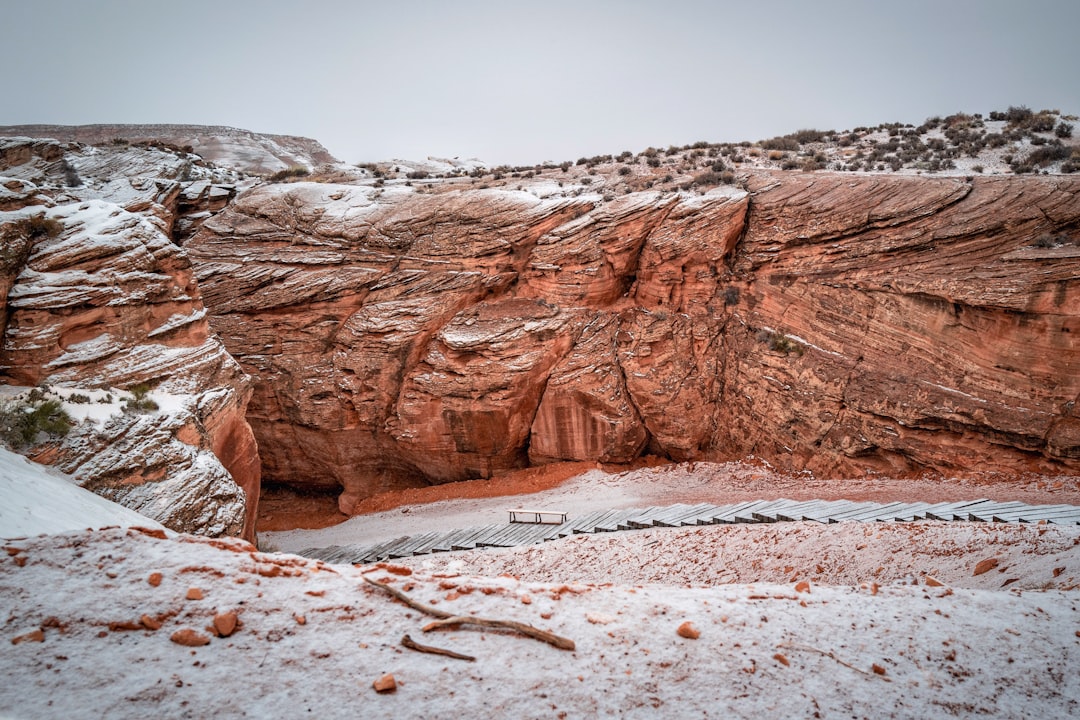 brown rock formation on white sand during daytime