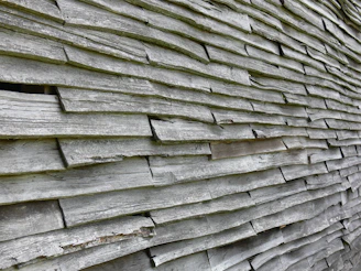 Close-up of sleek wood-plastic composite wall panels installed on a modern home's exterior, showcasing their texture and weatherproof finish.