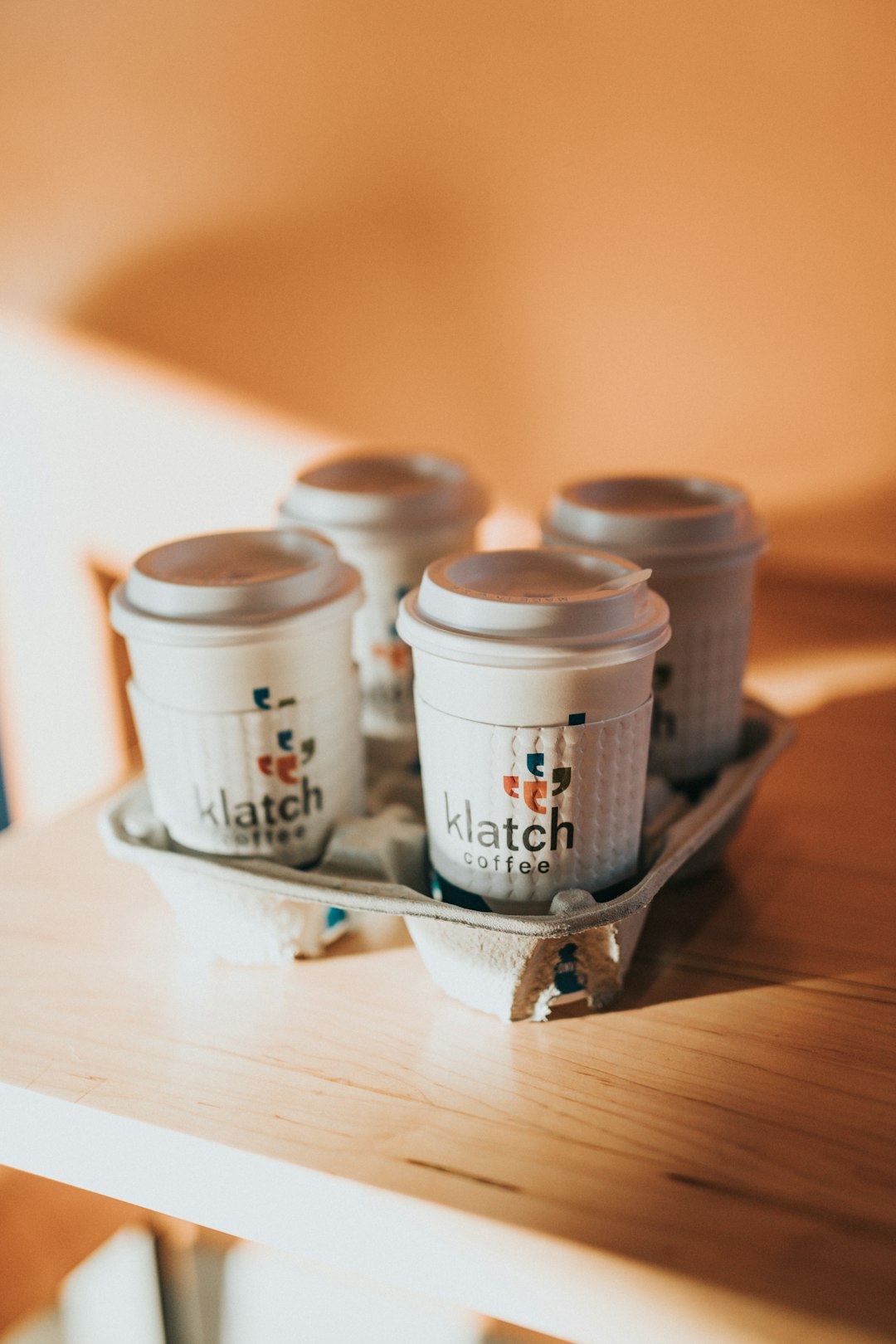 white and brown disposable cups on brown wooden table