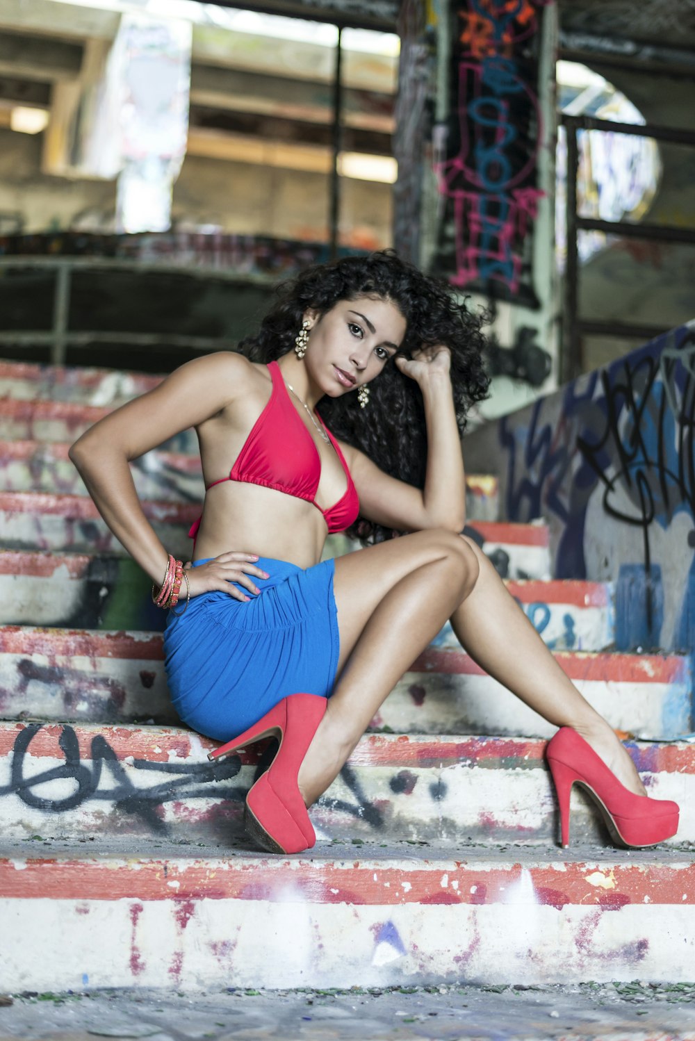 woman in red bikini sitting on concrete bench