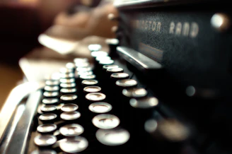 A close-up of a vintage typewriter with glowing circuit board patterns emerging from the keys.