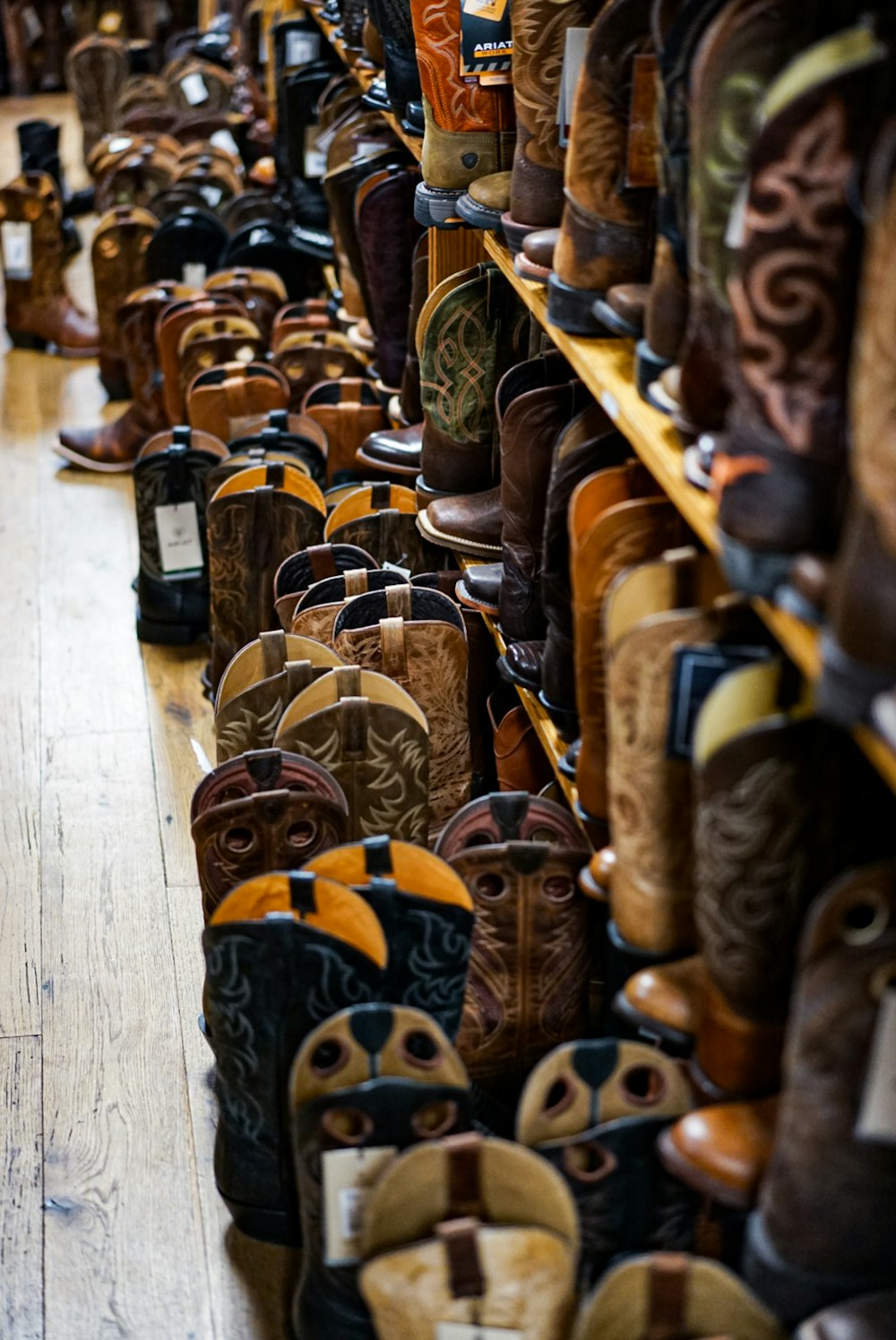 brown leather boots on brown wooden rack