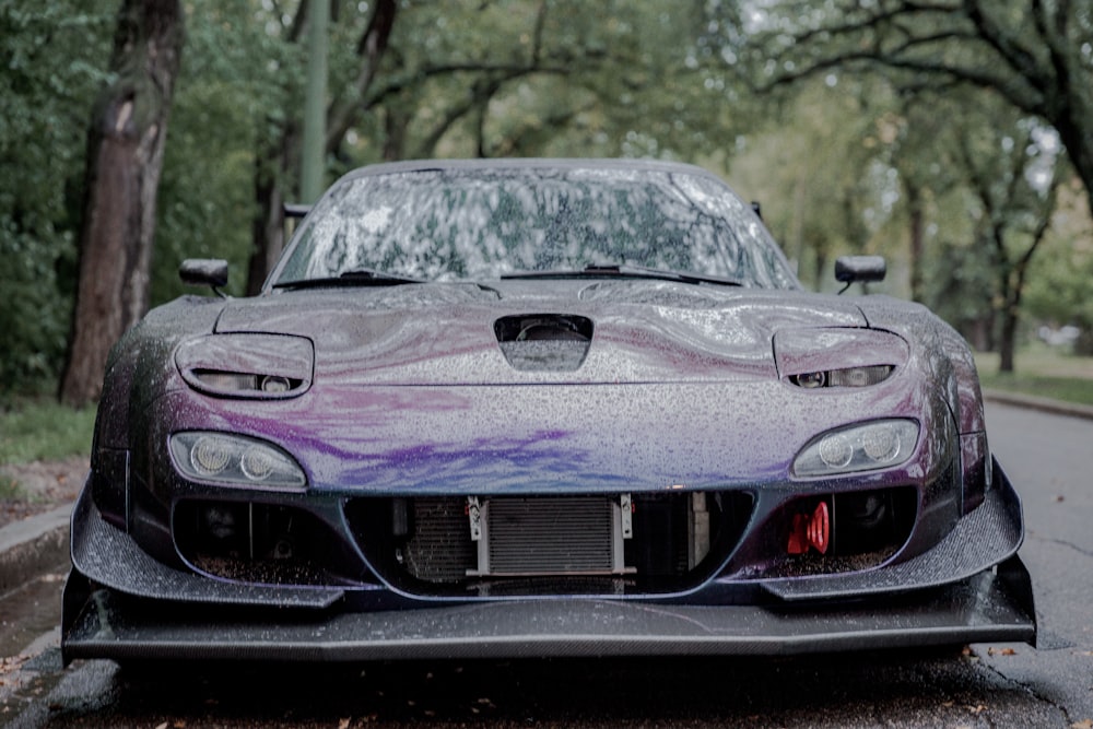 purple porsche 911 parked on road during daytime