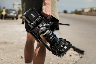 person holding black dslr camera