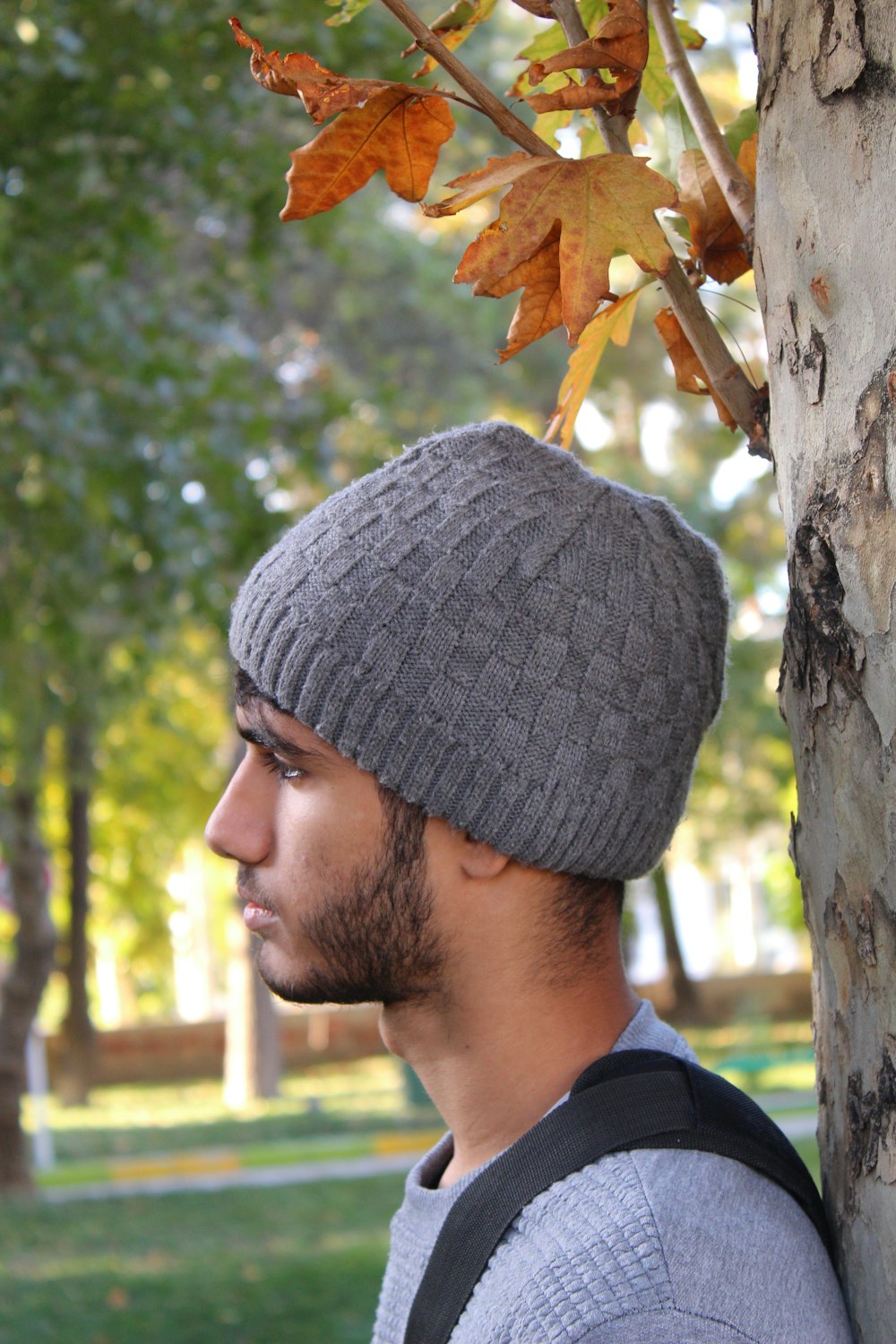 Hombre con camisa azul y gorro de punto gris