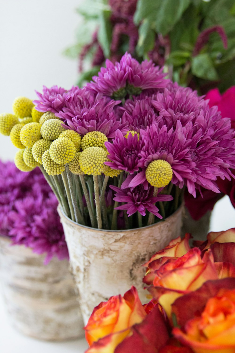 pink and green flower in white ceramic vase