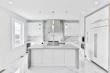 Minimalist kitchen with stone countertops and natural light pouring in