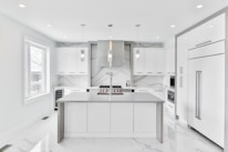 An elegant kitchen featuring custom cabinets and countertops.