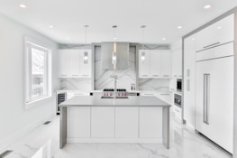 A beautifully designed kitchen featuring marble countertops and elegant decor.