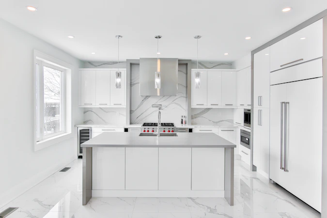 Clean well-maintained modern white kitchen with energy-efficient appliances