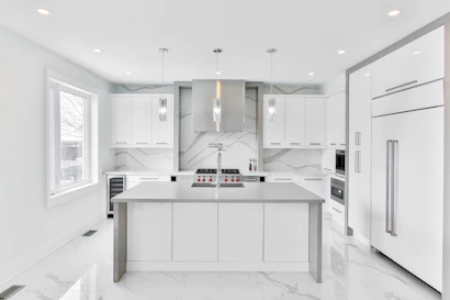 Luxury kitchen featuring sleek cabinetry and high-end finishes with a spacious open layout.