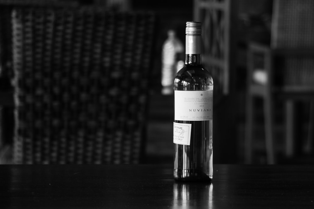 a bottle of wine sitting on top of a wooden table