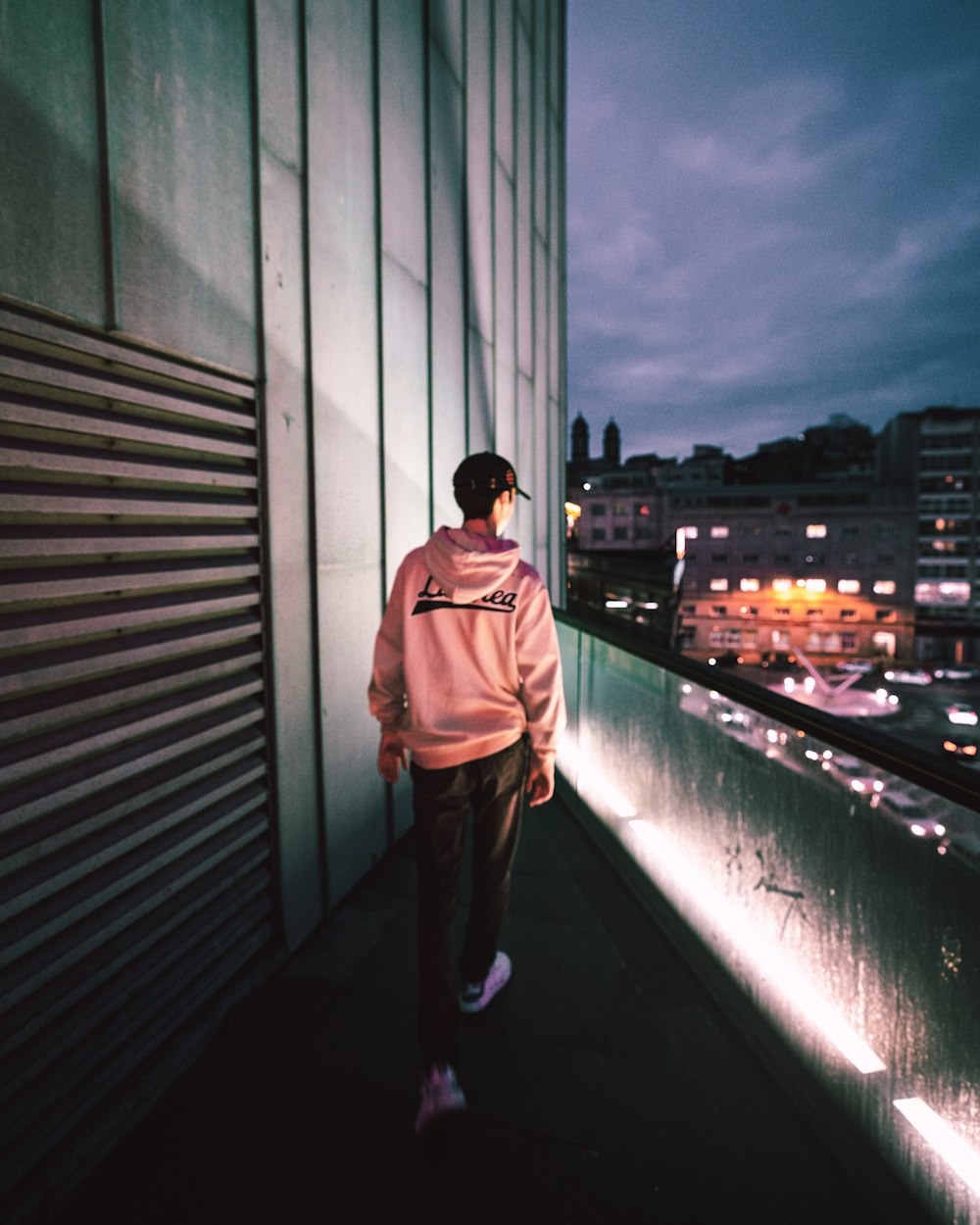 man in brown jacket standing on top of building during daytime