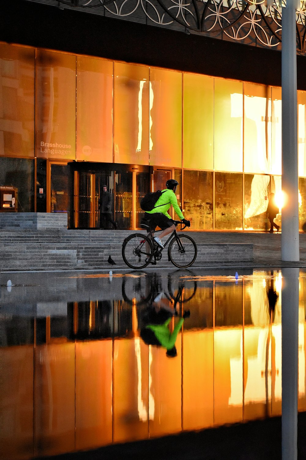 man in green jacket riding bicycle