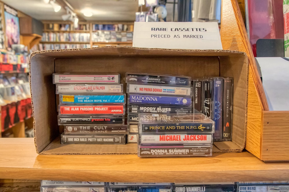 assorted books on brown wooden shelf