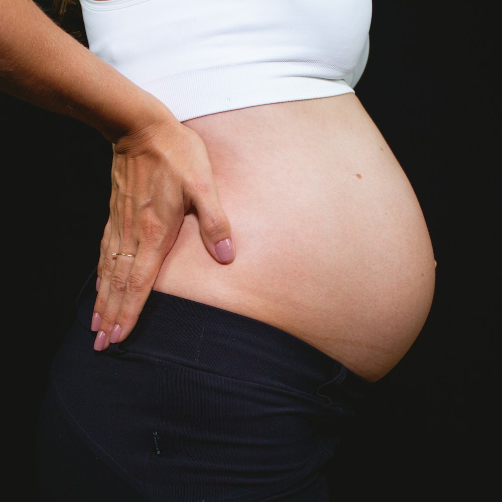 pregnant woman in white shirt and black skirt