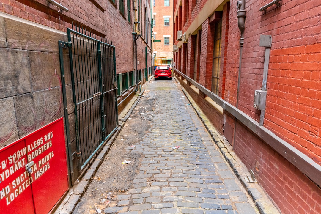 brown brick pathway between brown brick walls