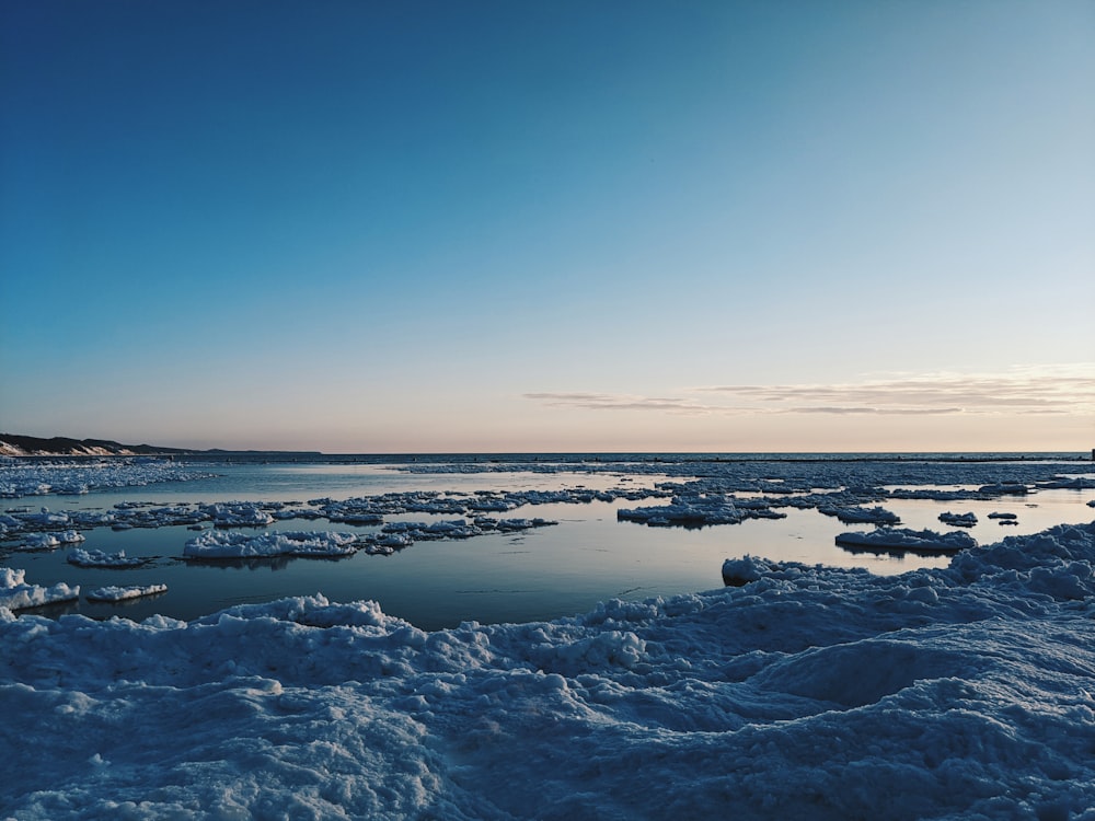 snow covered ground under blue sky during daytime