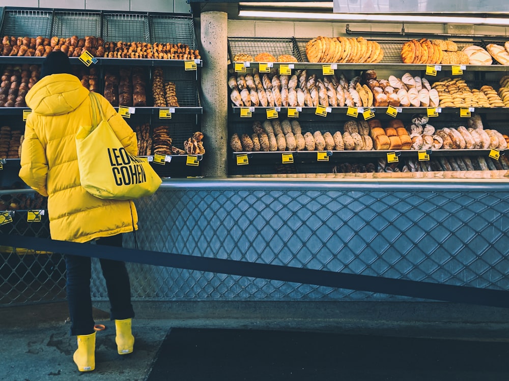 man in yellow and black nike jersey shirt standing in front of display counter