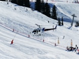 white and red cable car over snow covered mountain during daytime