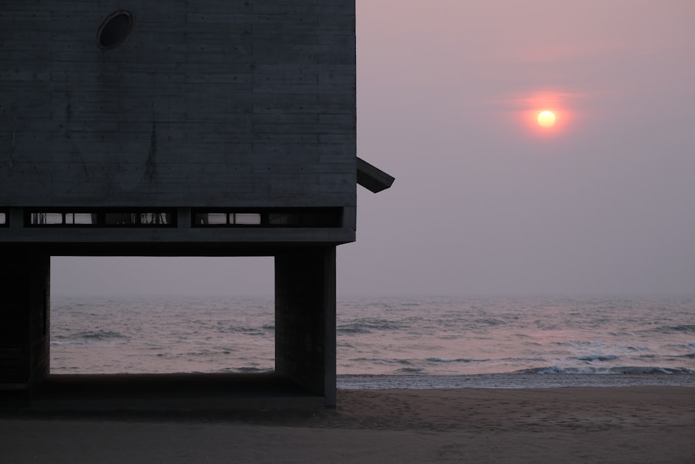 brown wooden dock on beach during sunset