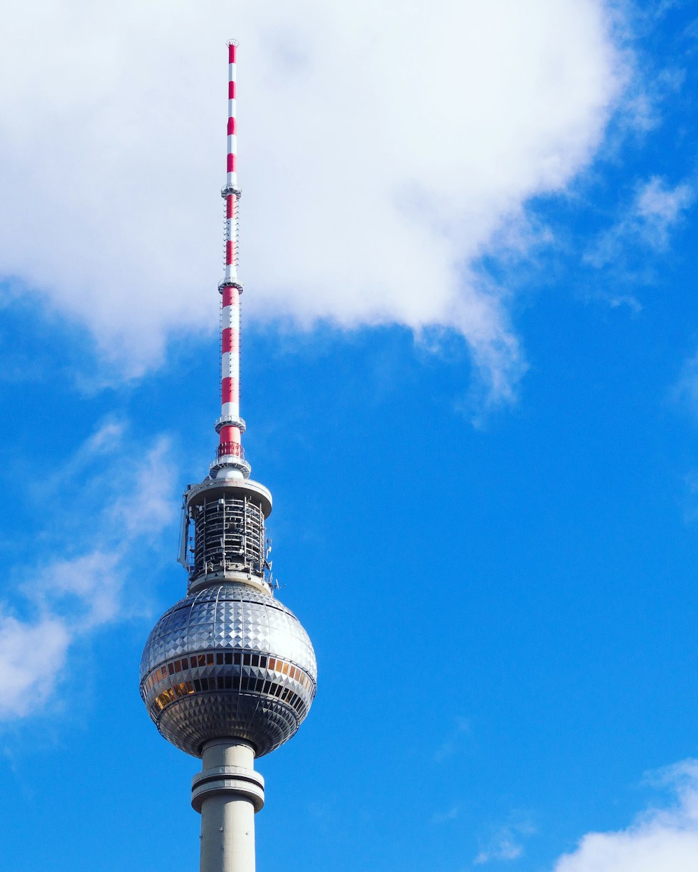 white and red tower under blue sky