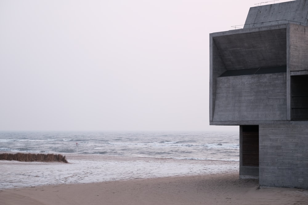 gray concrete building on beach during daytime