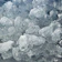 Close-up of clear crushed ice cubes glistening under sunlight.