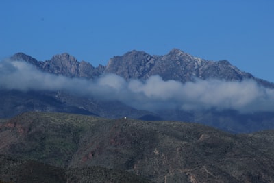 green and brown mountain under blue sky during daytime mountain range google meet background