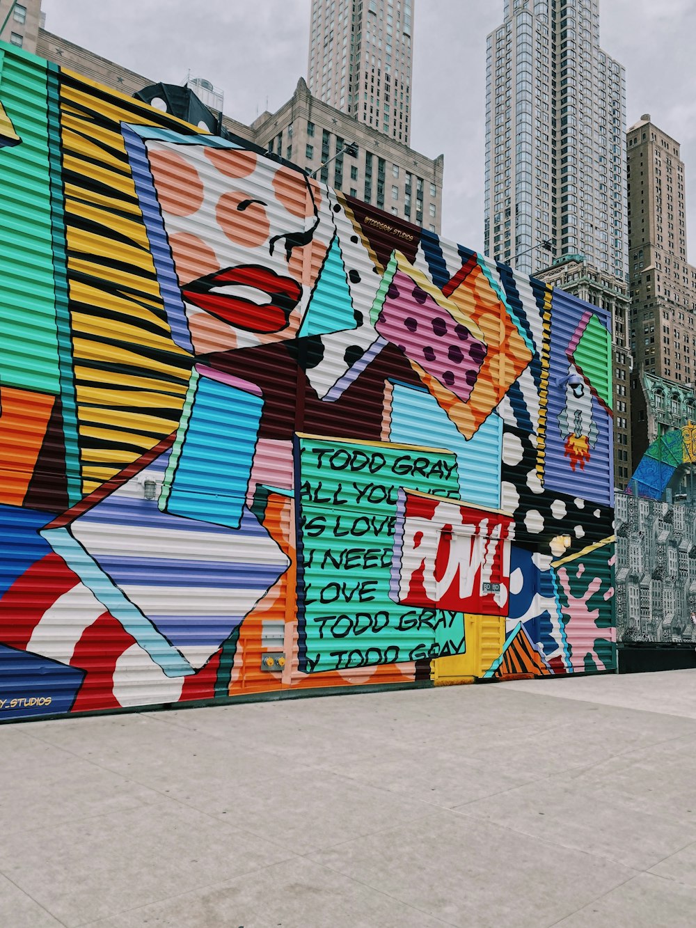 red blue and yellow graffiti on wall