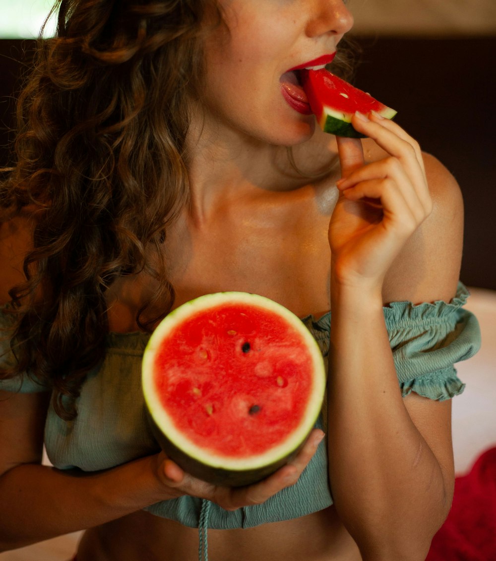 woman holding sliced watermelon fruit