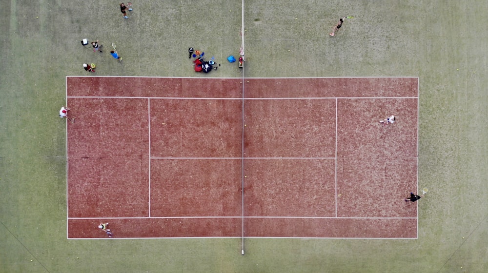 people playing soccer on field during daytime