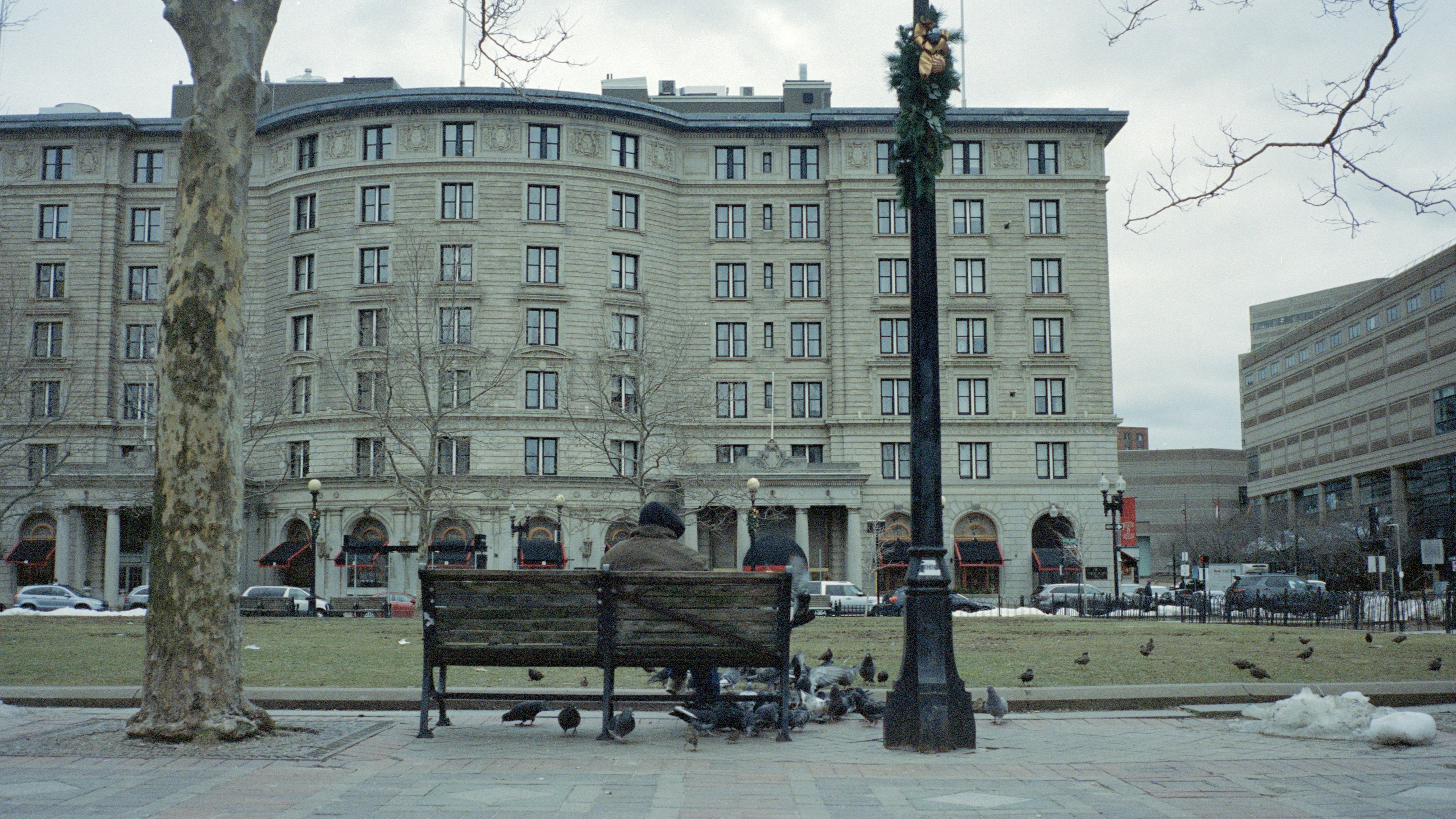 People sitting on bench near building during daytime
