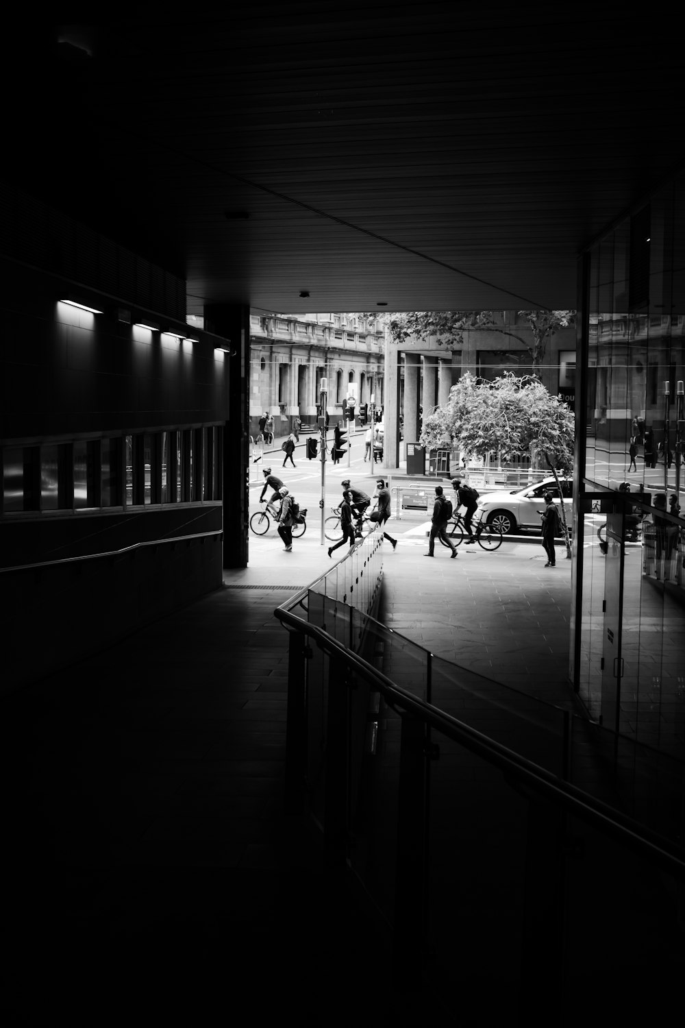 grayscale photo of people sitting on bench