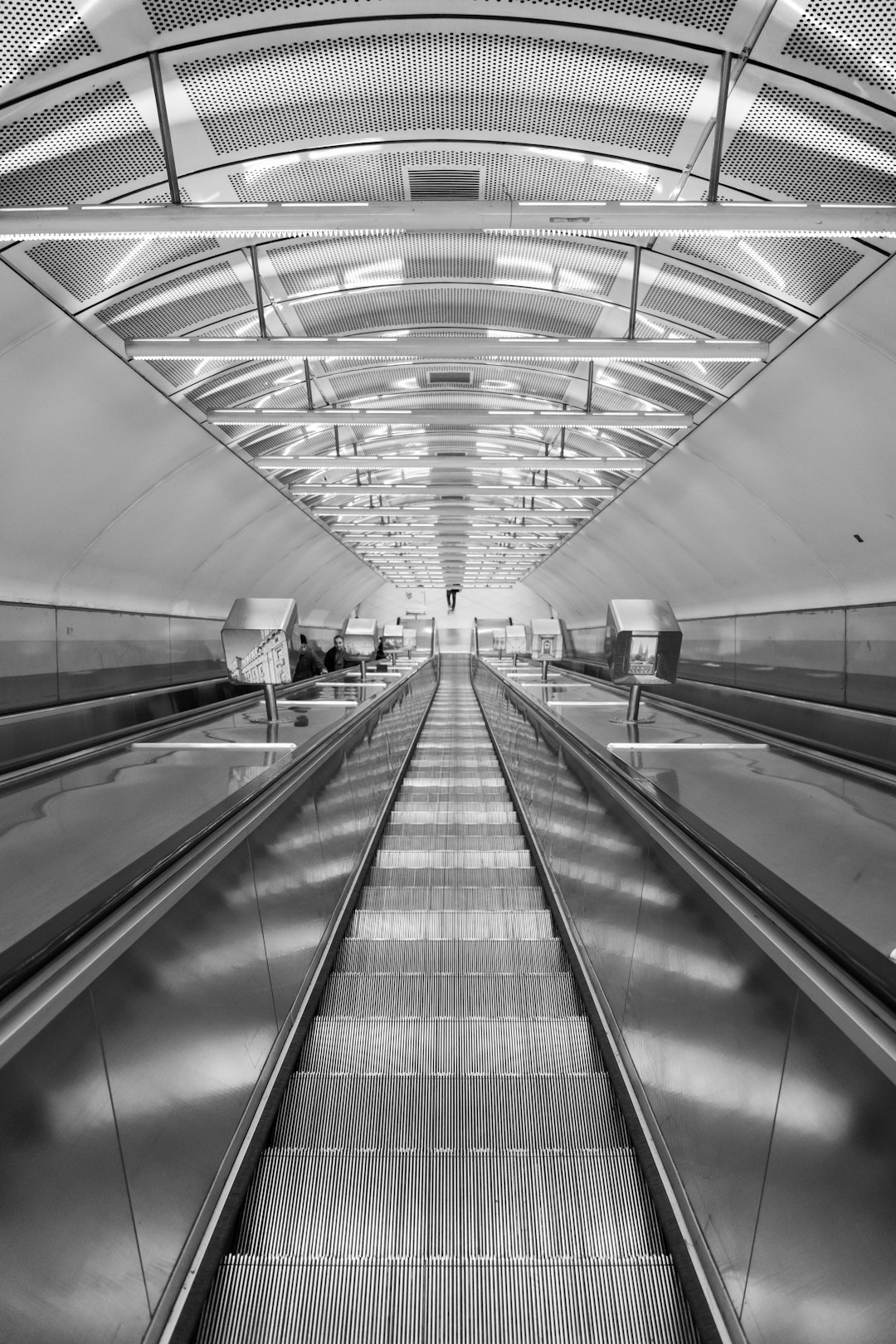 black and silver escalator in a train station