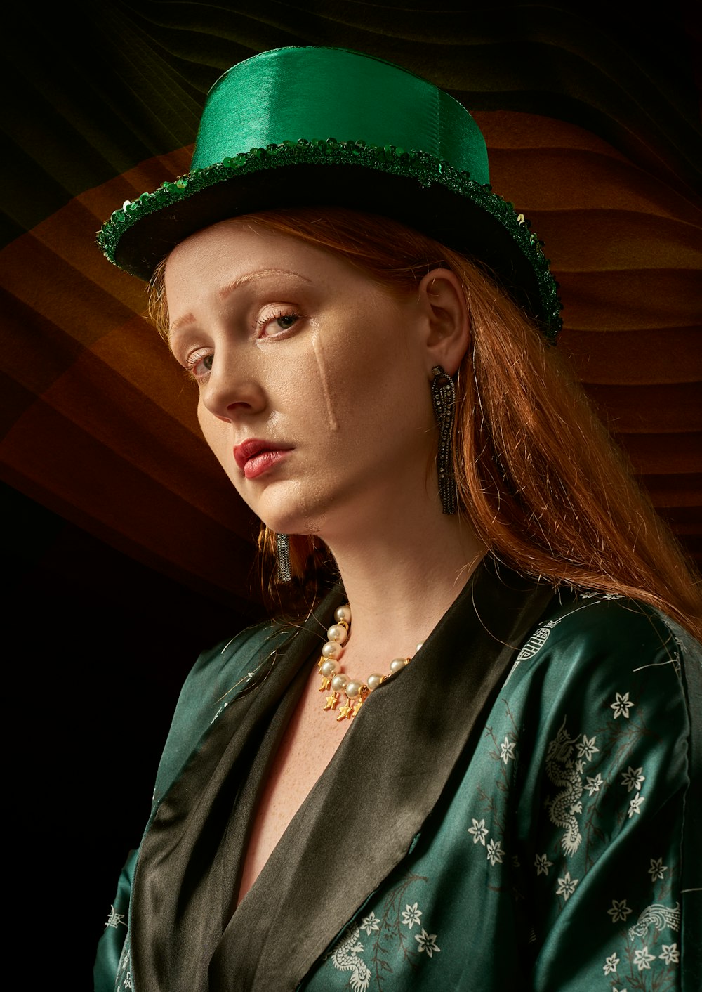 woman in green and white floral shirt wearing green hat