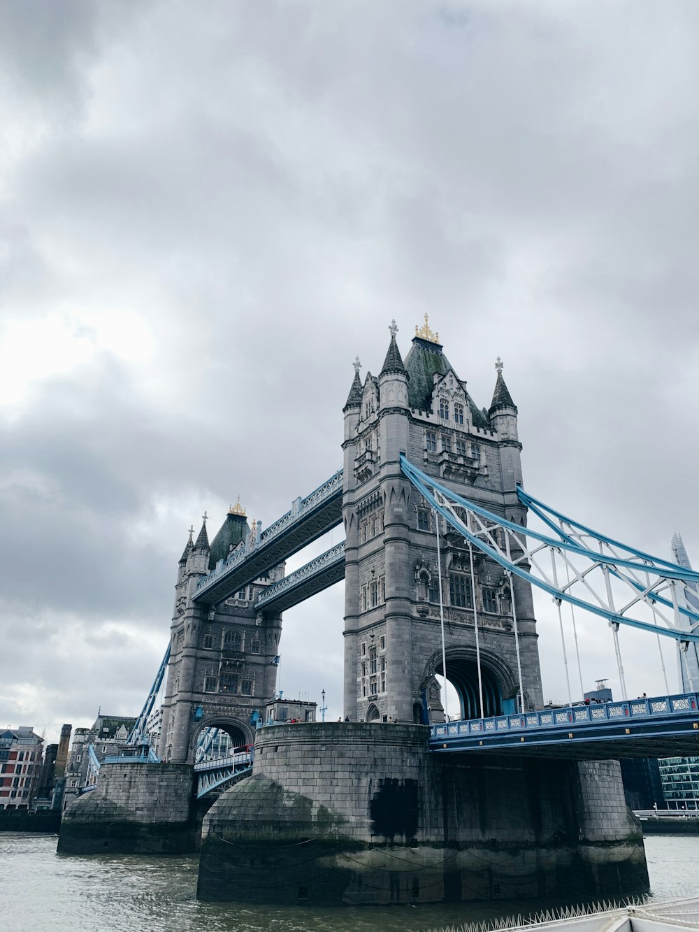 gray concrete bridge under cloudy sky during daytime