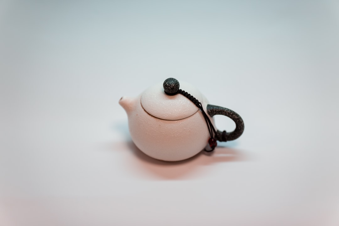white ceramic teapot on white table