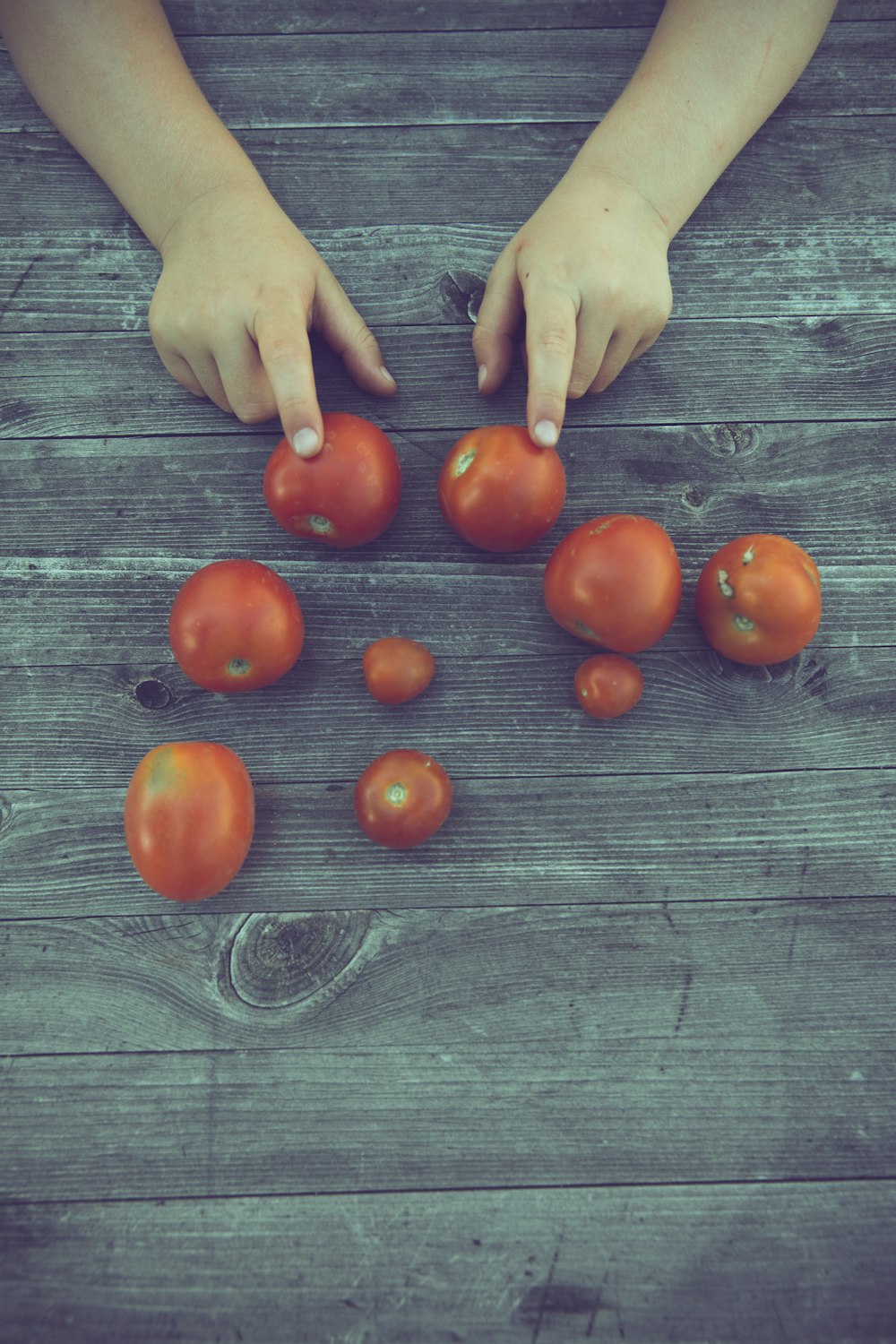 red tomato on gray wooden table