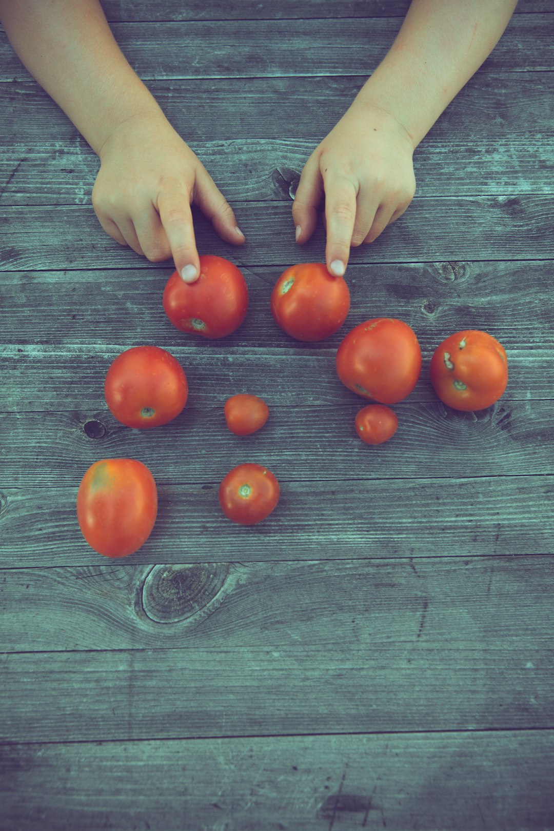 red tomato on gray wooden table