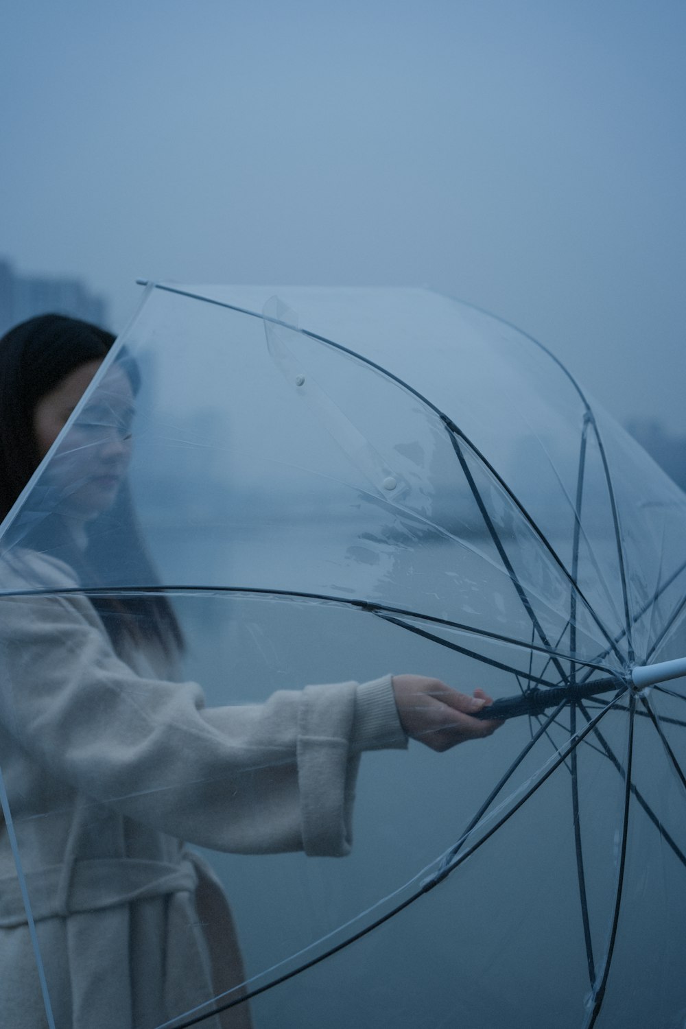 woman in white long sleeve shirt holding umbrella