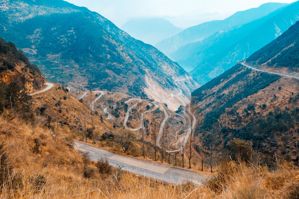 aerial view of road between mountains during daytime