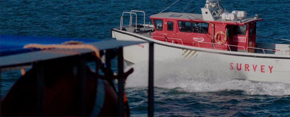 white and red boat on sea during daytime