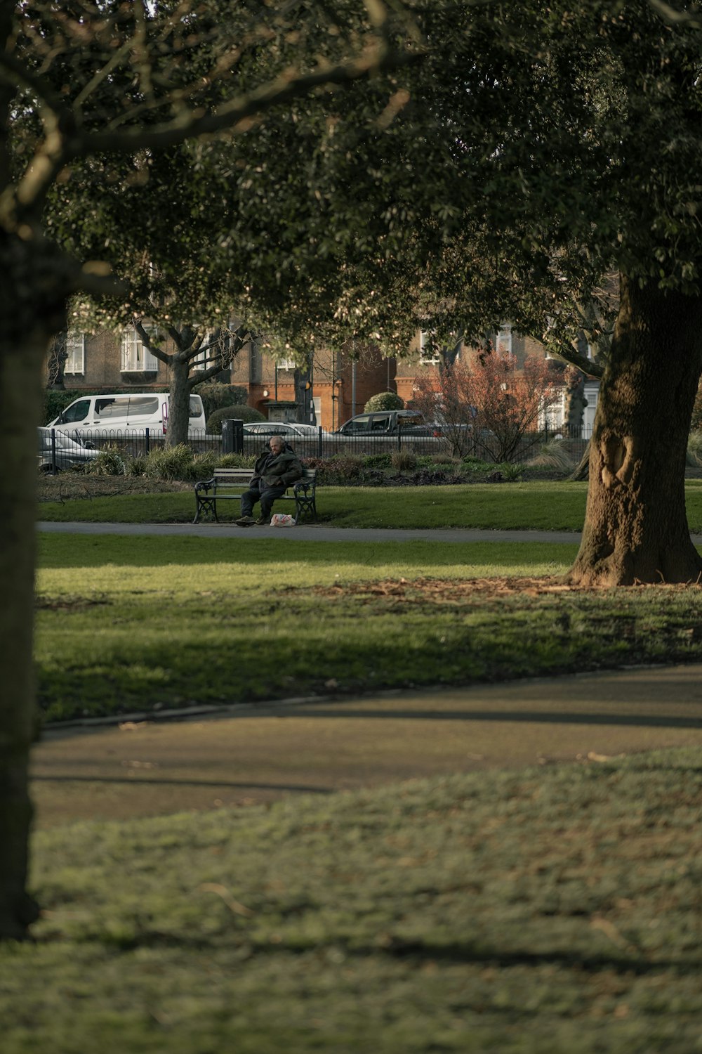 black motorcycle parked on green grass field near brown concrete building during daytime