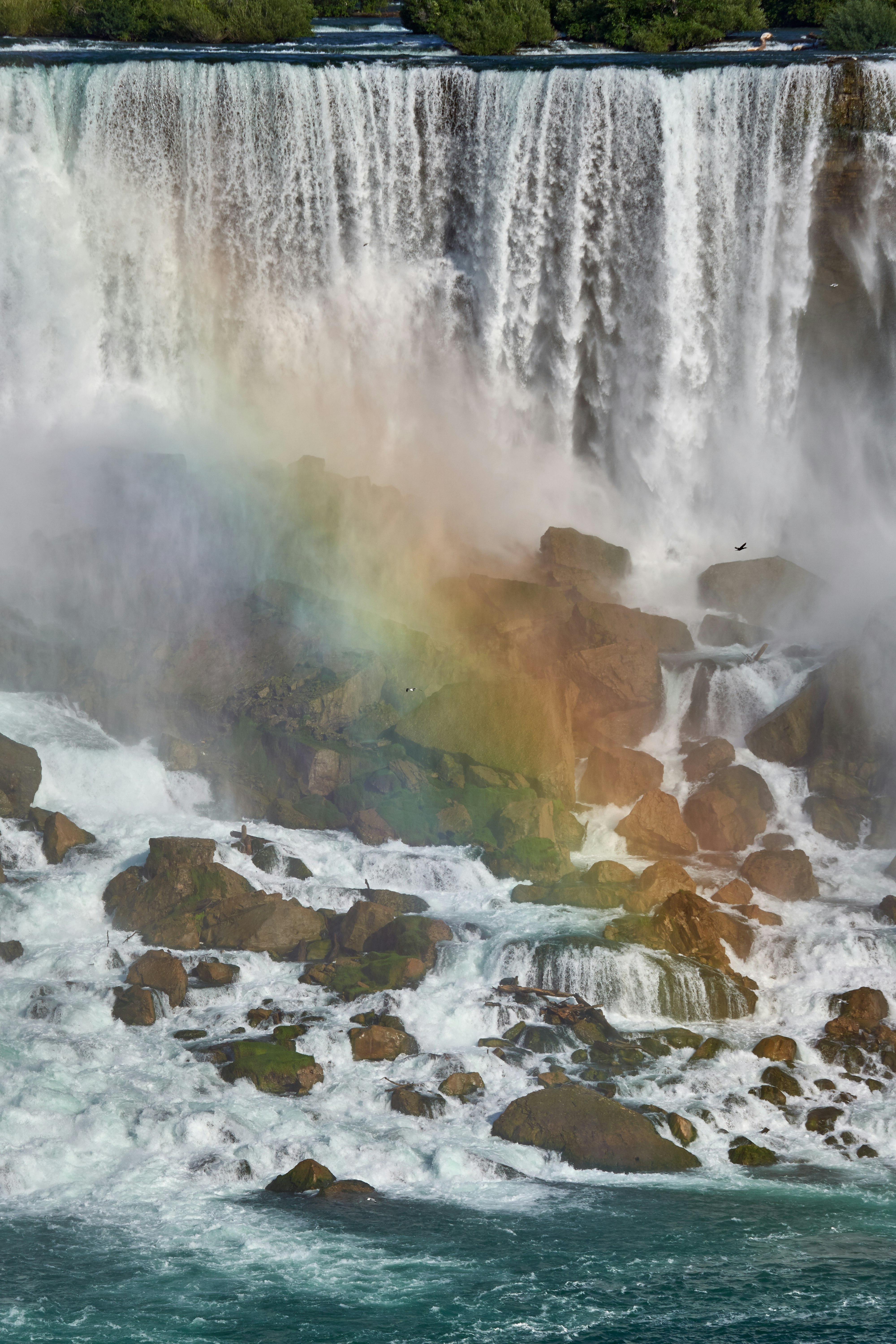 water falls on brown rocky mountain