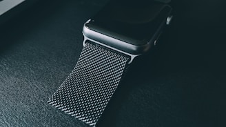 Close-up of the sleek MF Ring glowing softly on a wrist, highlighting its steel design and digital interface.