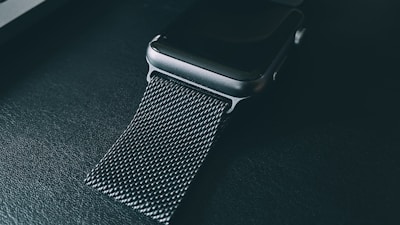 Close-up of the sleek MF Ring glowing softly on a wrist, highlighting its steel design and digital interface.