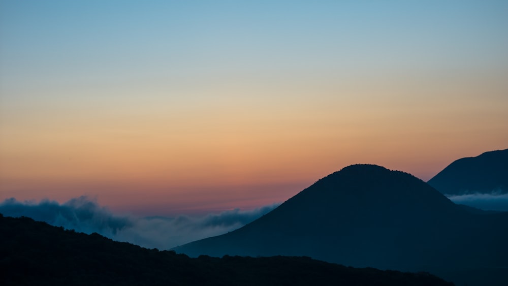 silhouette of mountain during sunset