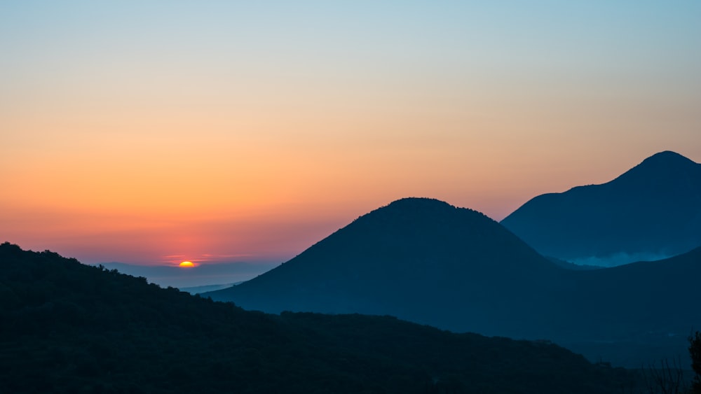 silhouette of mountain during sunset